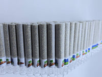 A diagonal row of rolling paper joints filled with a light gray-green herbal blend, lined with white paper and decorated with colorful cartoon-style labels, set against a plain white background.